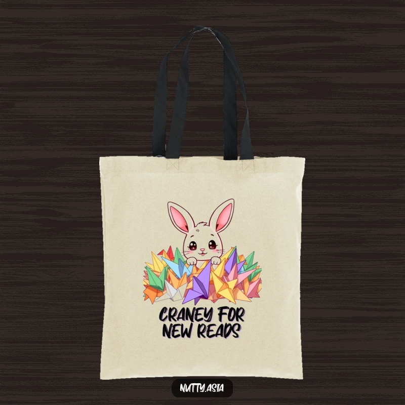 Funny tote bag featuring a cute bunny peeking curiously from a colorful pile of origami cranes, ready for adventure.